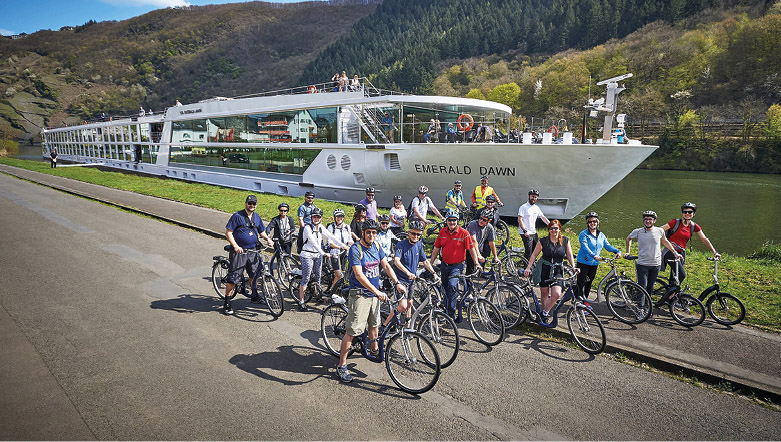 Group of people on bikes in front of a luxury river cruise ship