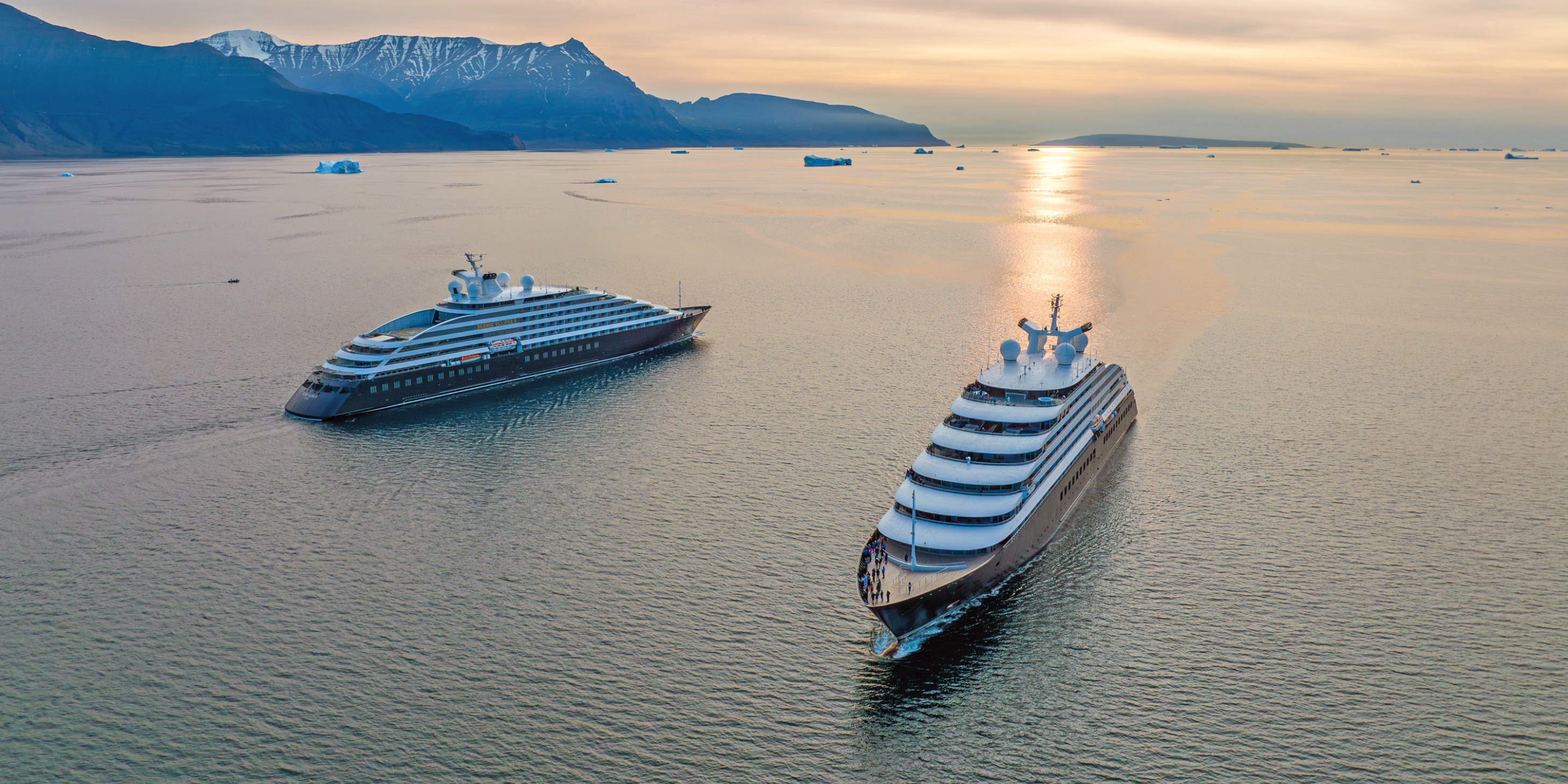 both ocean cruise discovery yachts sailing next to each other in Disko Bay Greenland