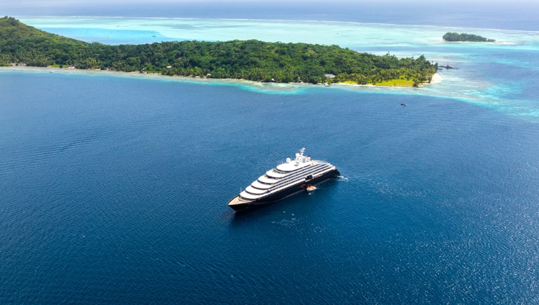 luxury ocean cruise discovery yacht sailing in the blue waters of bora bora next to an island cove