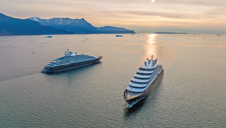 both ocean cruise discovery yachts sailing next to each other in Disko Bay Greenland