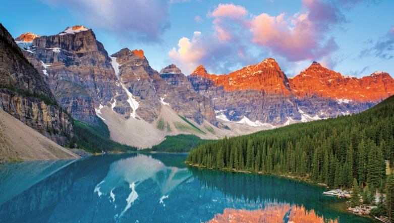 View of Lake Banff in Canada with the sun hitting the peaks of the mountains