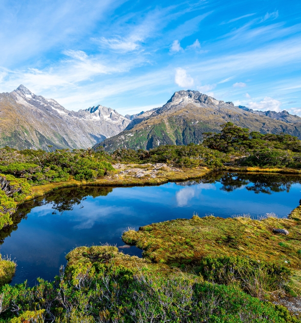A river in front of some mountains in New Zealand