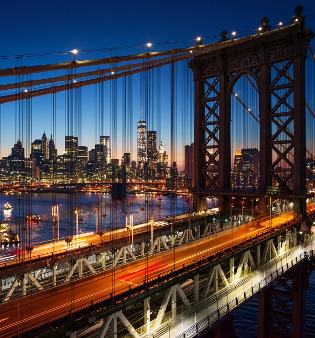 The Manhattan Skyline through the wires of the Brooklyn Bridge in North America