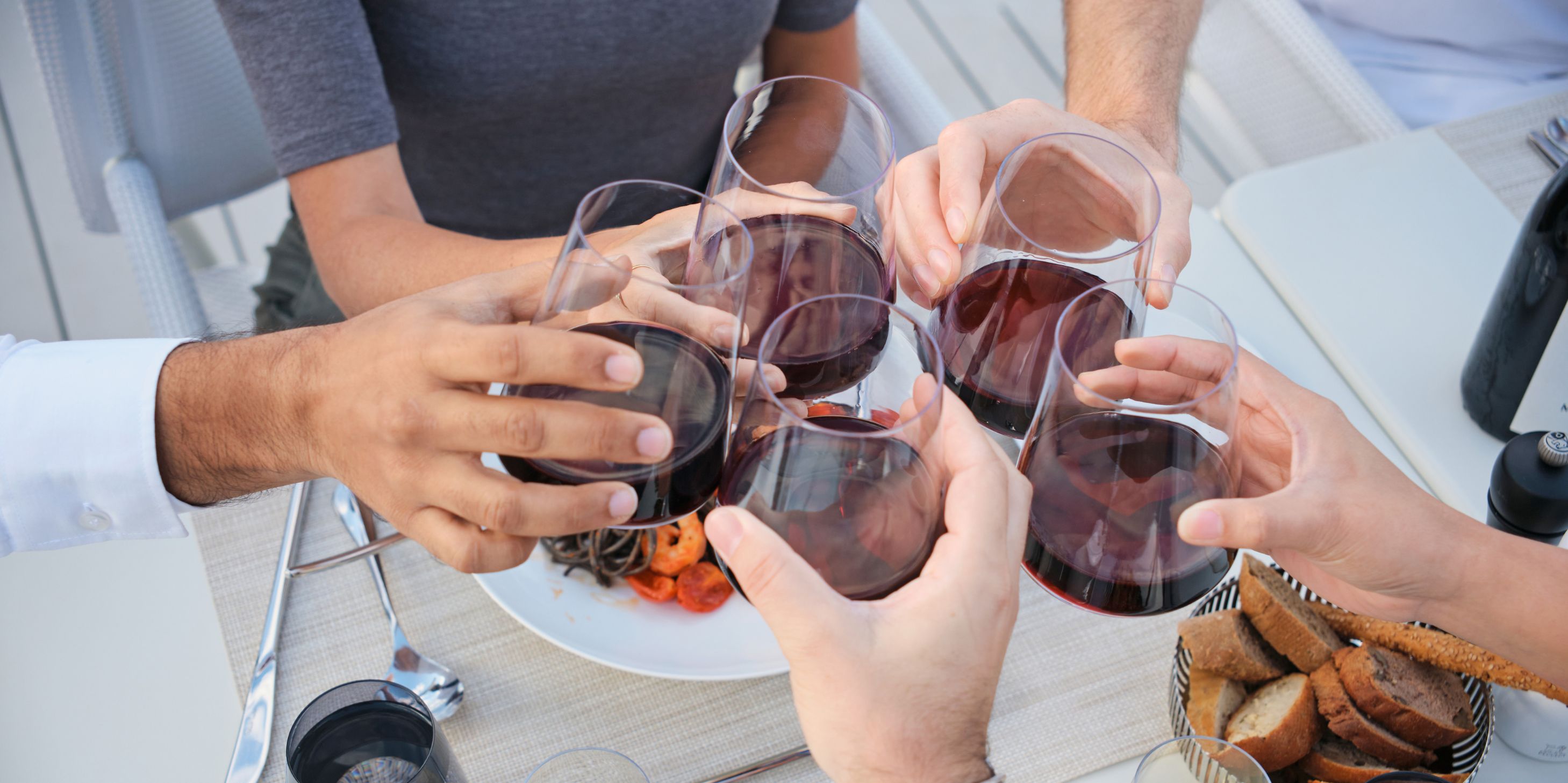 five wine glasses clinking together
