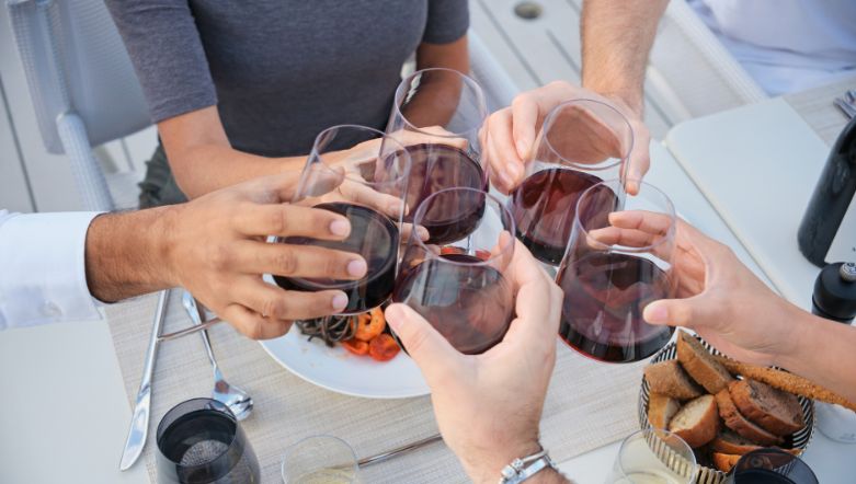 five wine glasses clinking together
