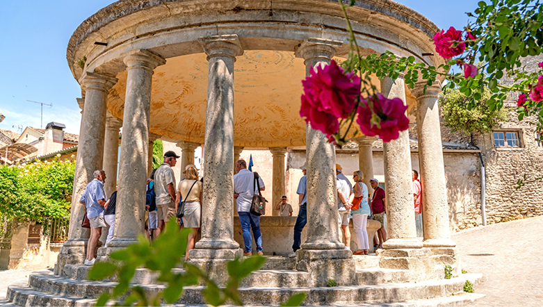Group of tourists walking around an ancient ruin